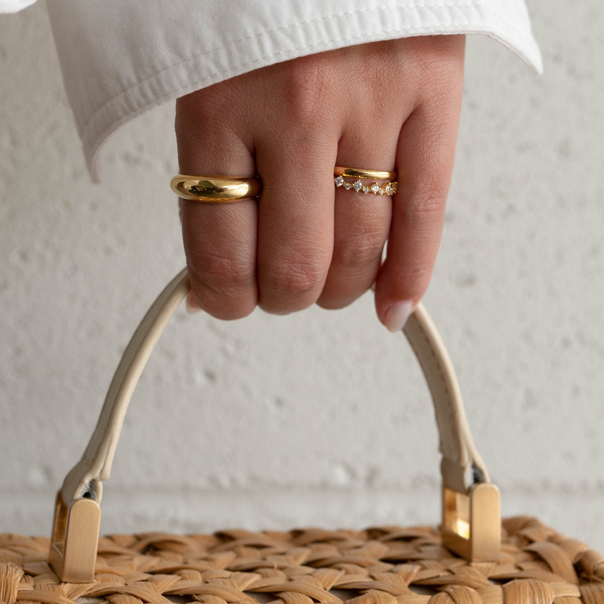 Gold-plated band ring on finger, thick smooth band with shine