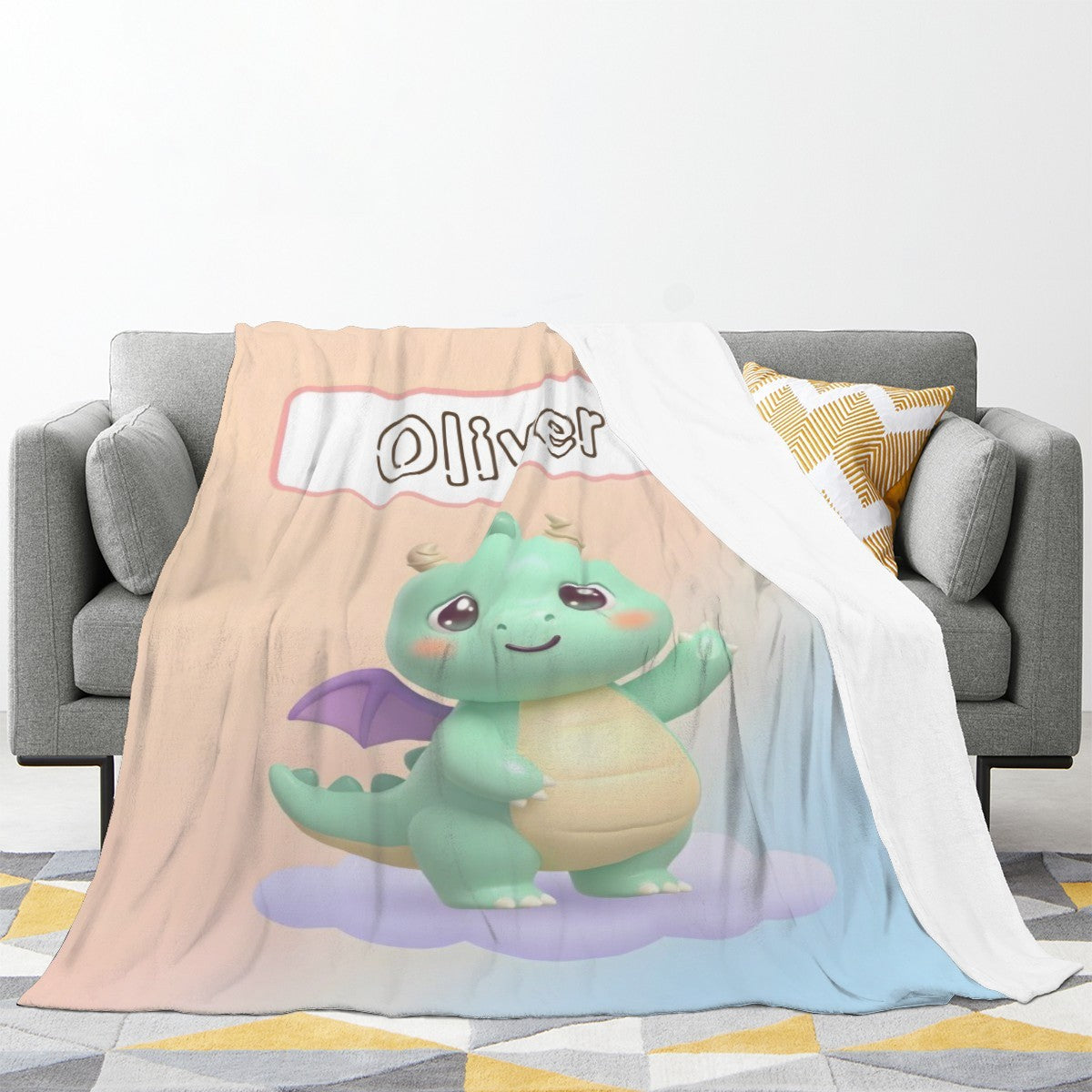 Light pink and blue flannel blanket draped on a couch, with green dragon mascot