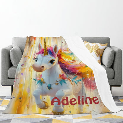 Unicorn flannel blanket with rainbow mane and name Adeline, draped over sofa