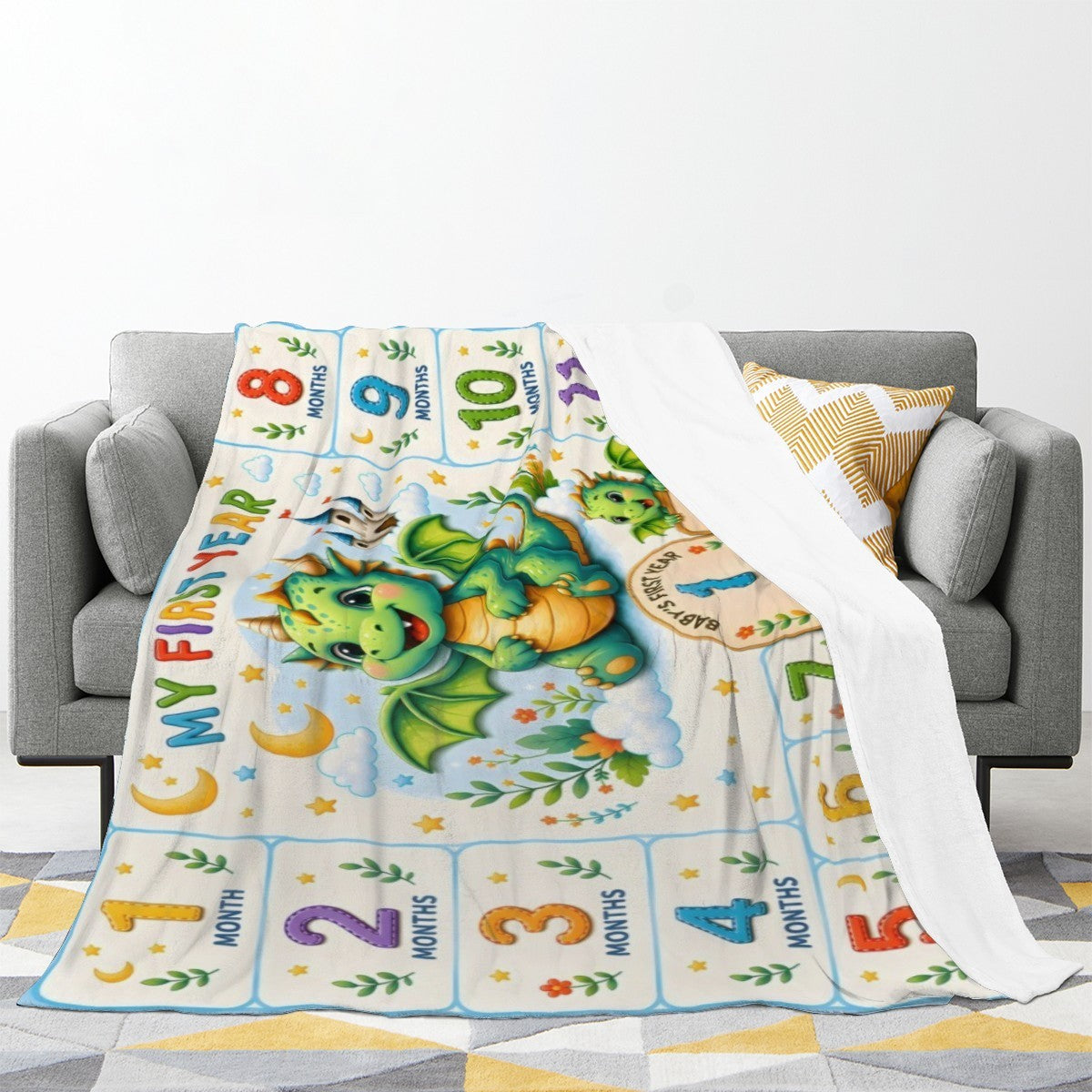Milestone dragon blanket on couch, blue-white print with green dragon and month blocks