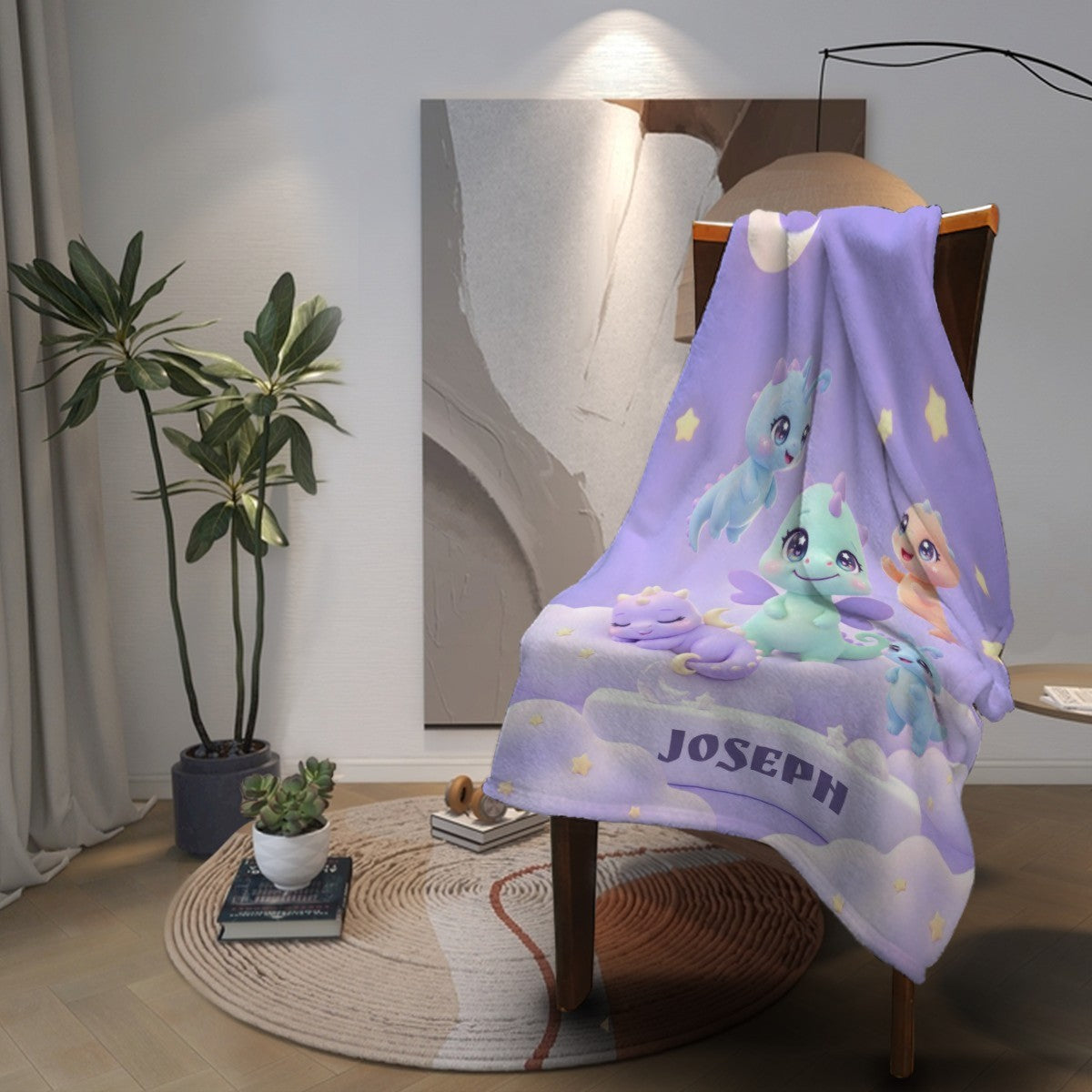 Purple flannel blanket with cartoon dragons and 'JOSEPH' text, draped over chair