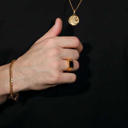 Black onyx-style square signet ring on hand, gold PVD finish