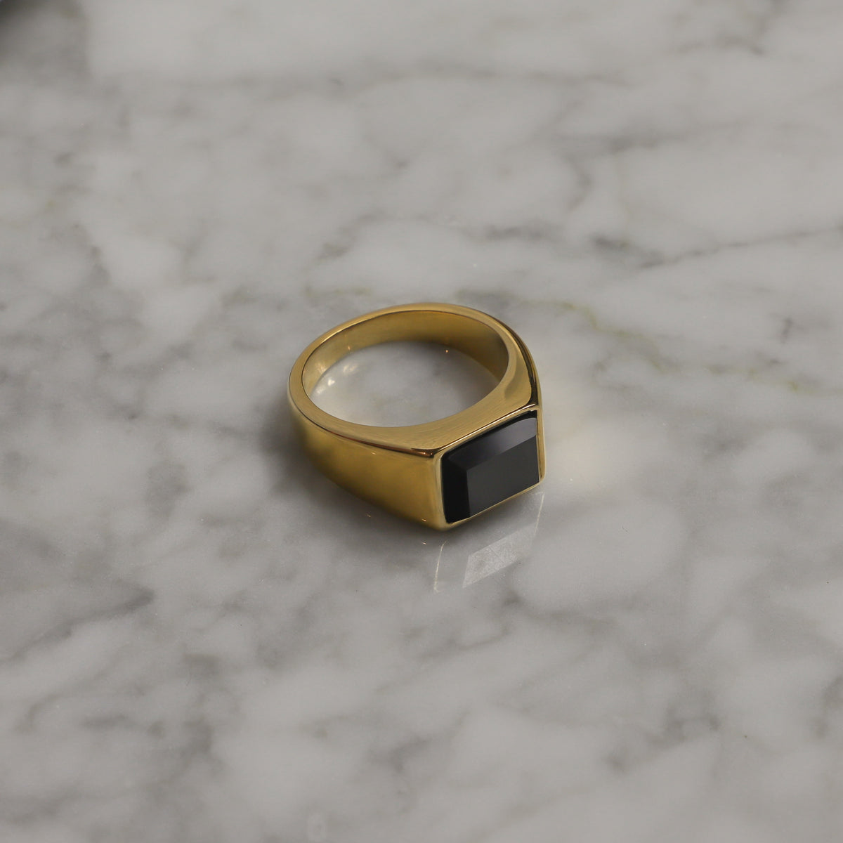 Gold PVD signet ring with square black onyx-style stone, wide band