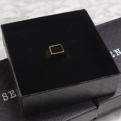 Square black signet ring on black display box insert
