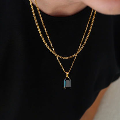 Gold-tone onyx pendant necklace with stacked chain links and rectangular charm