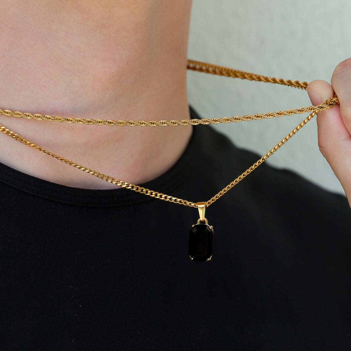 Gold-tone onyx pendant necklace set with rectangular black stone charm