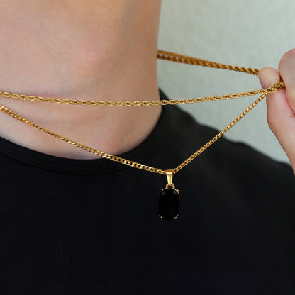 Gold-tone onyx pendant necklace set with rectangular black stone charm