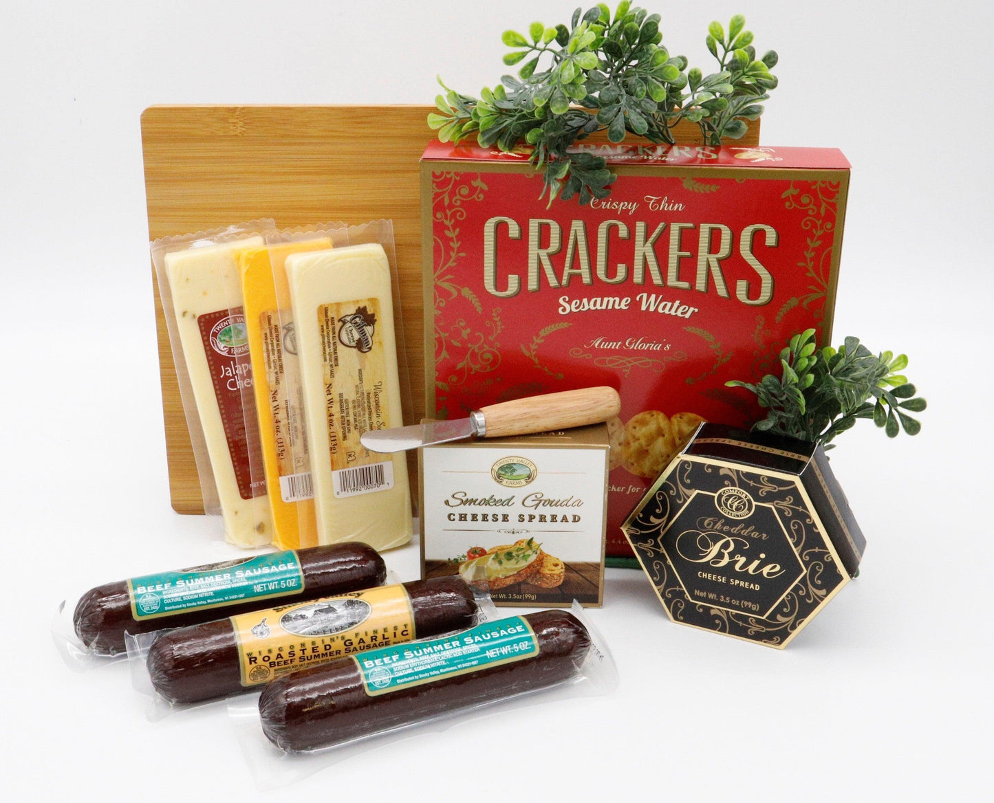Wooden cutting board gift set with crackers, cheese spreads, and packaged meats