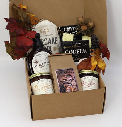 Breakfast gift box open with jars, coffee, preserves, and cake mix packets