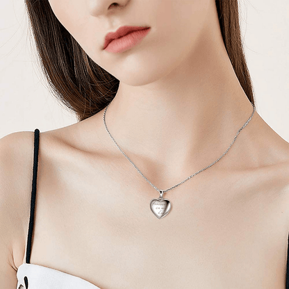 Heart photo locket necklace on a woman’s neck with silver chain and heart pendant