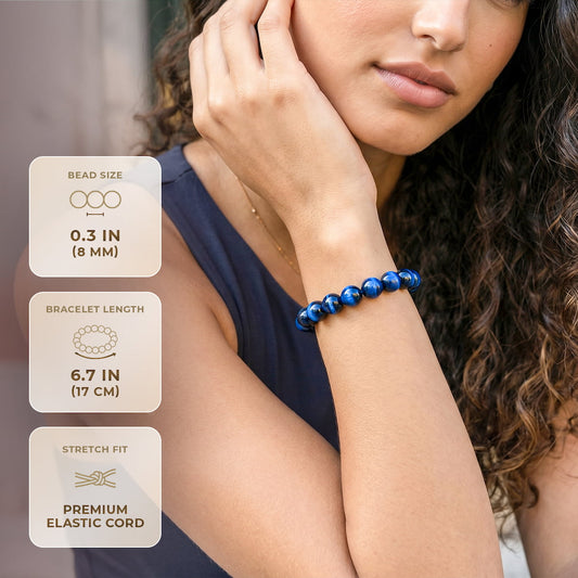 Blue Tiger's Eye bracelet with dark blue round beads on wrist, elastic stretch band