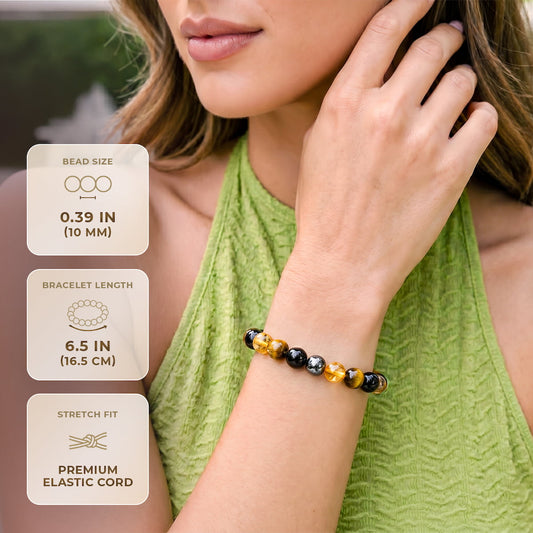 Black and amber beaded bracelet on wrist with round stones and elastic stretch fit.