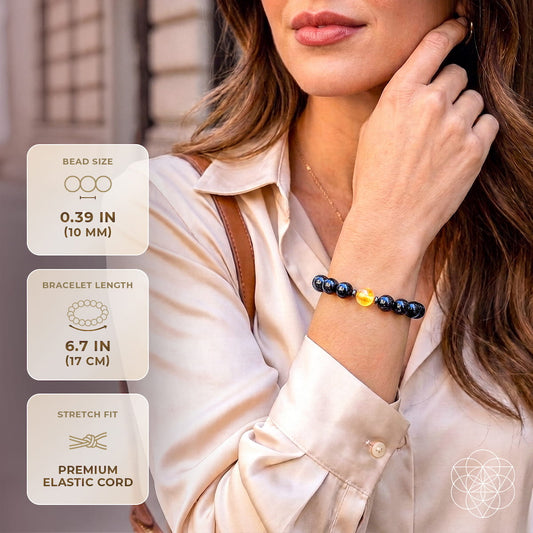 Arfvedsonite deep healing bracelet on wrist with dark beads and a golden quartz center