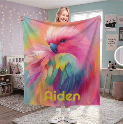 Personalized parrot name blanket with colorful feather artwork and yellow name text