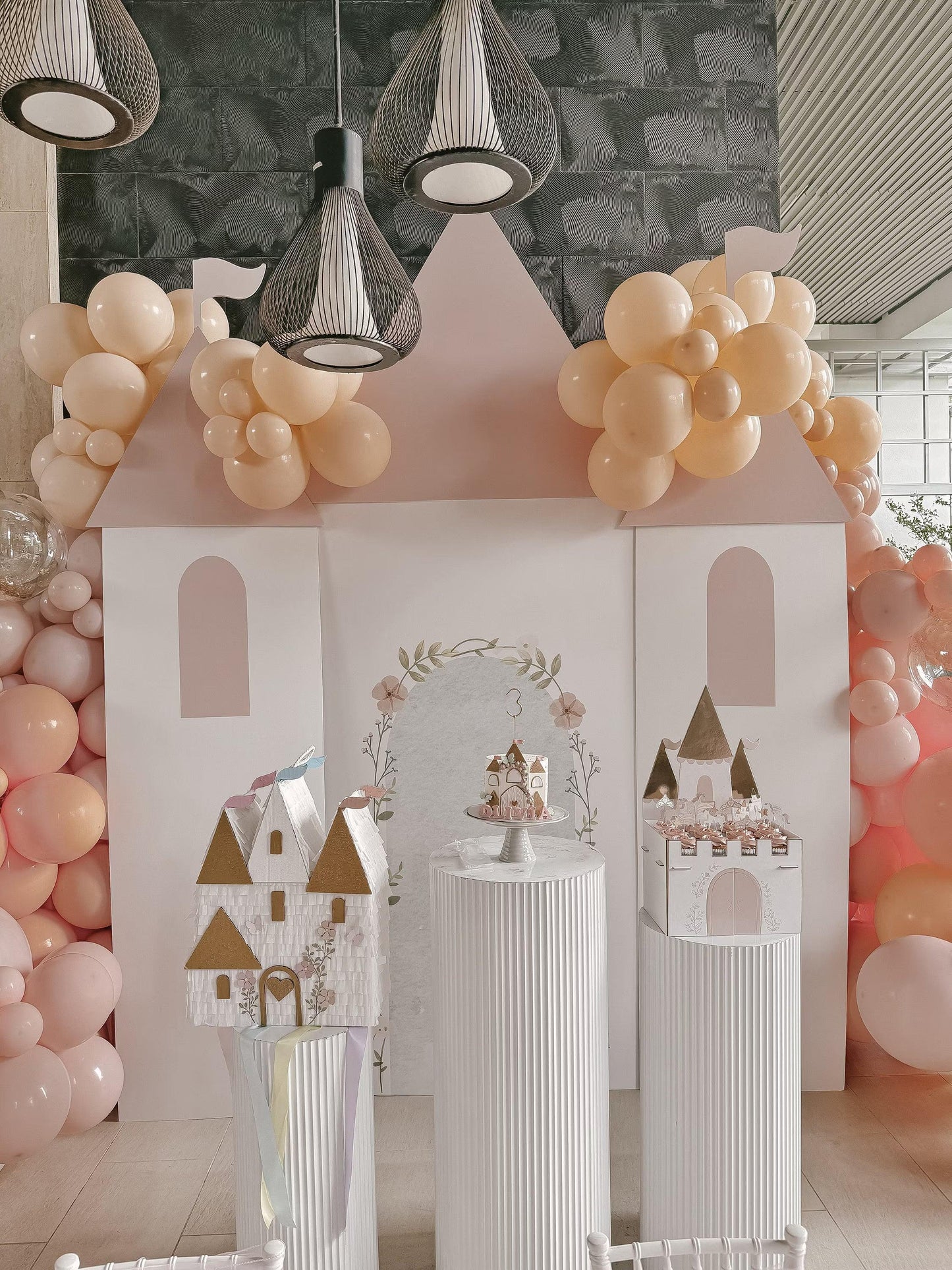 Castle piñata decoration with white walls, gold-roof towers, arched doorway and windows