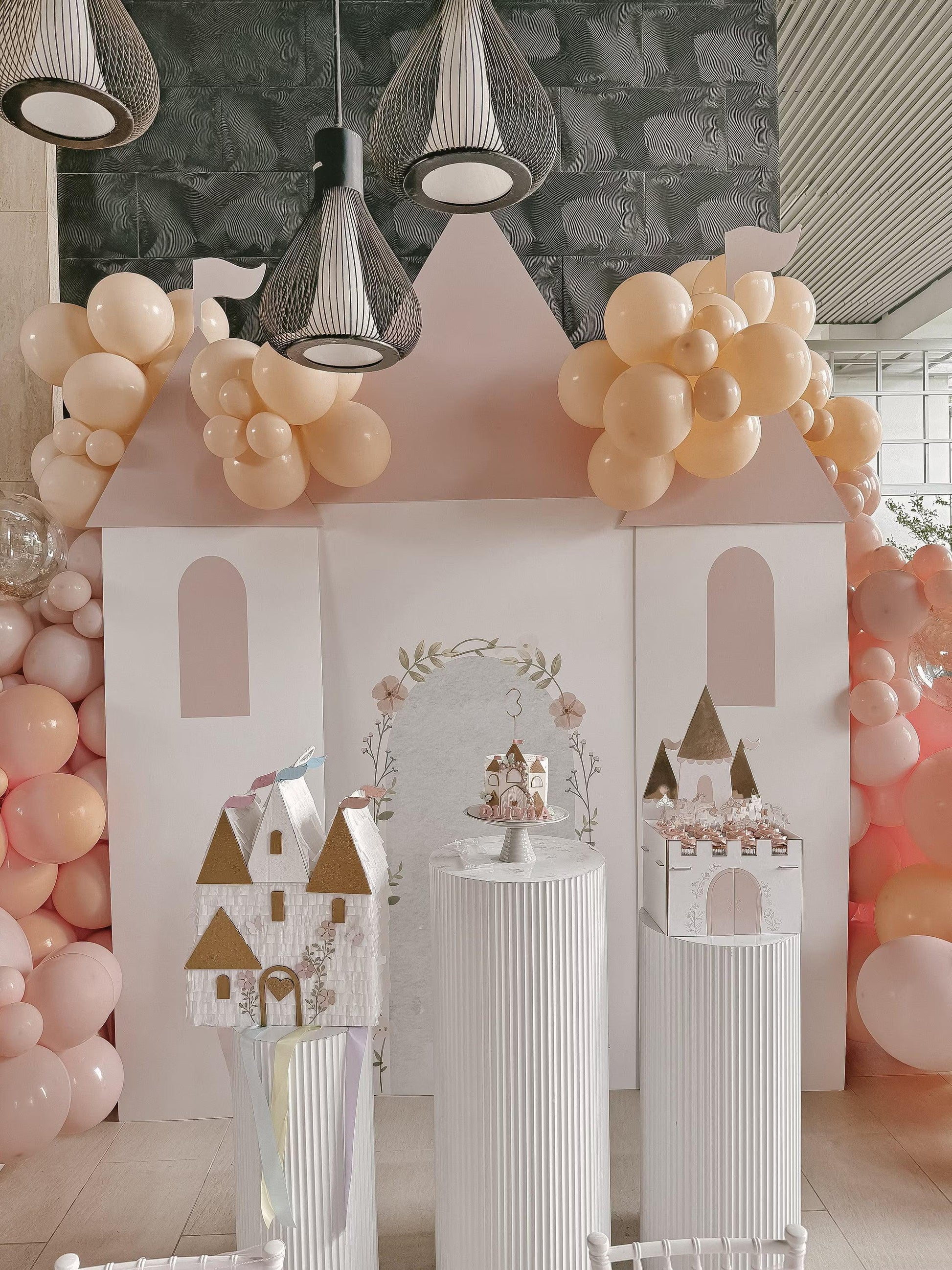 Castle piñata decoration with white walls, gold-roof towers, arched doorway and windows