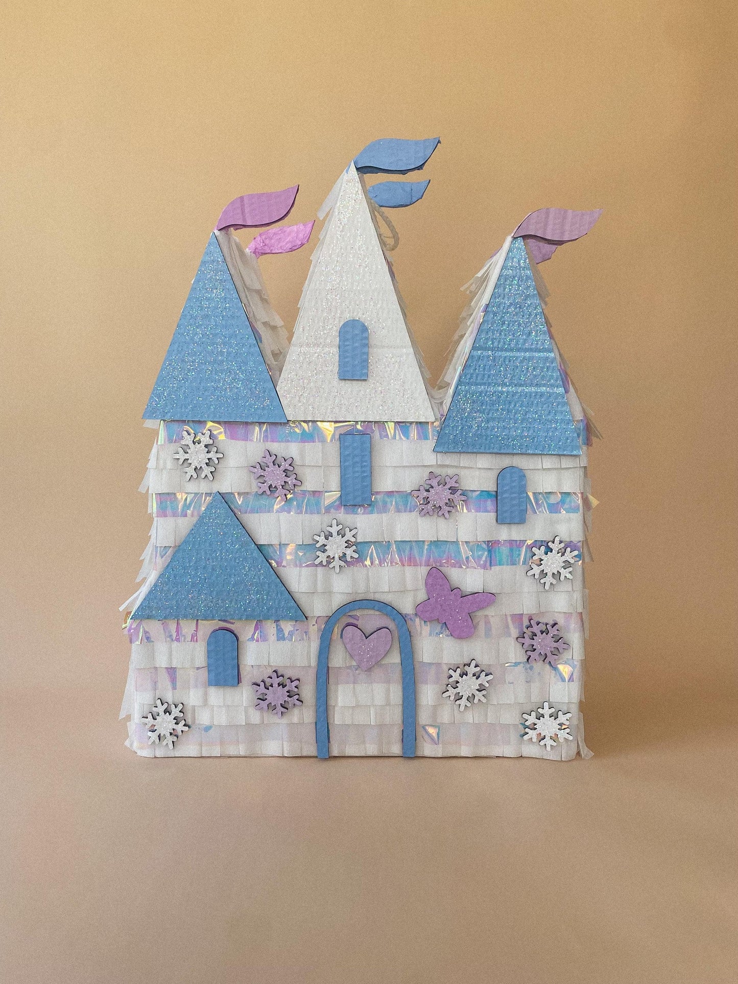 Handmade castle piñata in blue and purple with heart door, window cutouts, snowflakes