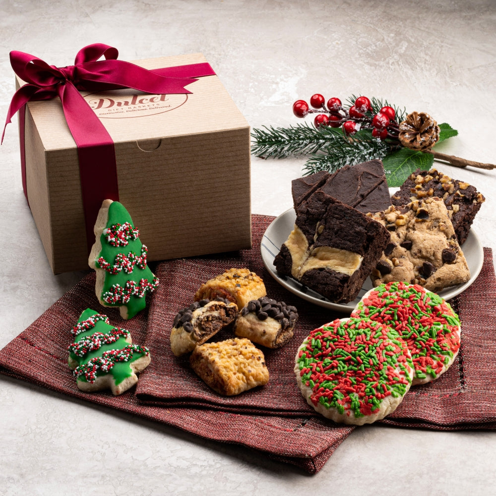 Kraft gift box with ribbon, assorted cookies, and holiday decorations
