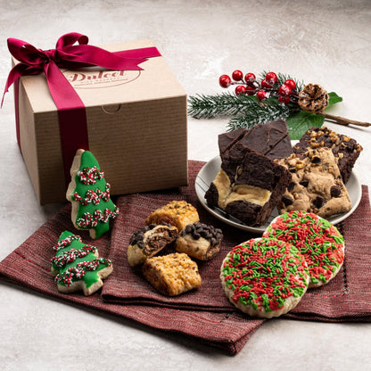 Kraft gift box with ribbon, assorted cookies, and holiday decorations
