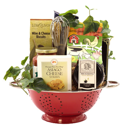 Italian gift basket in a red colander with cheese straws, bruschetta, and pasta