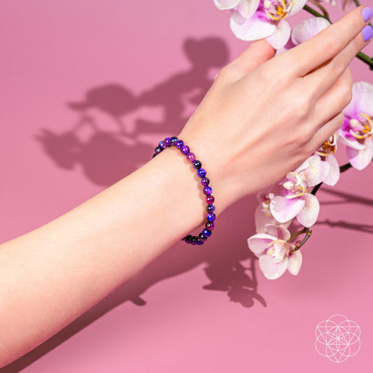 Purple and blue beaded bracelet worn on wrist