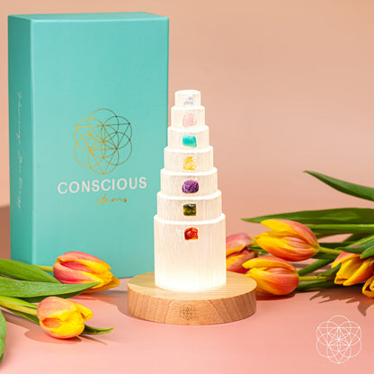 Glowing crystal stack tower lamp with multicolor gemstone insets on round wood base