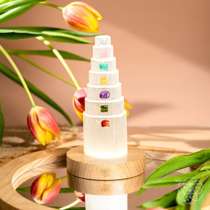 Glowing crystal stack lamp on round wooden base with multicolor gemstone insets