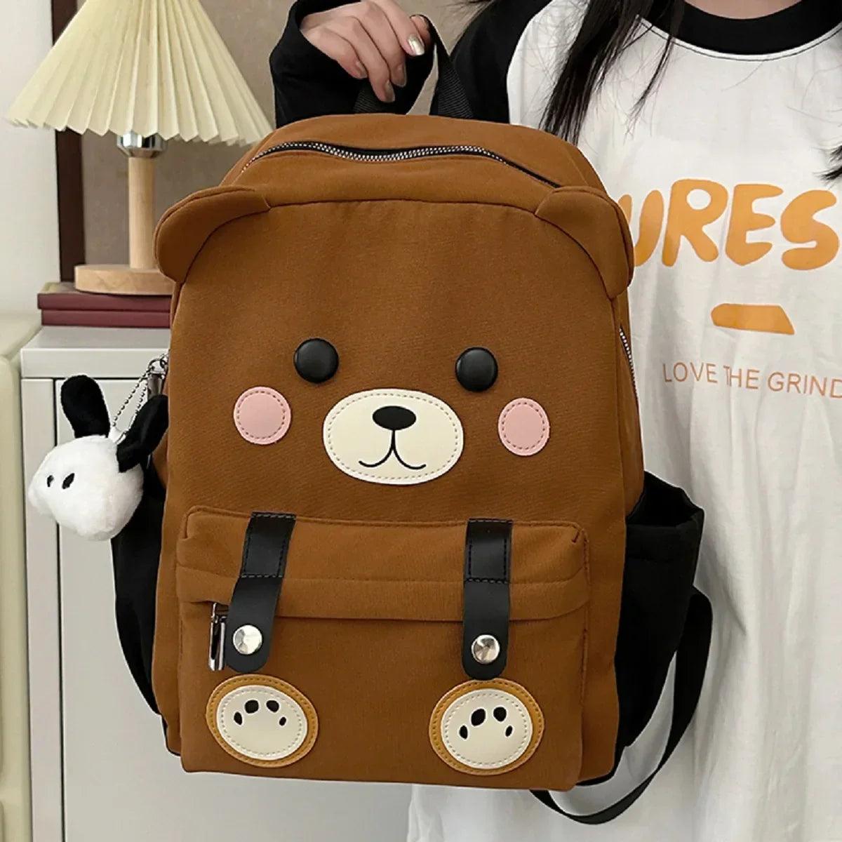 Brown cute bear backpack with bear-face patch, pink cheeks, and two front pockets