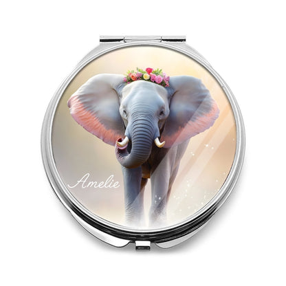 Silver compact mirror with a floral-crowned elephant illustration and name on the cover.