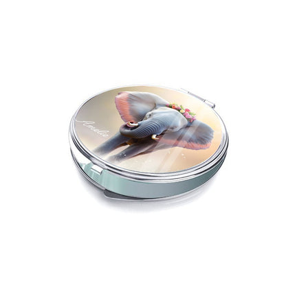 Side view of a silver compact mirror with a floral elephant cover.