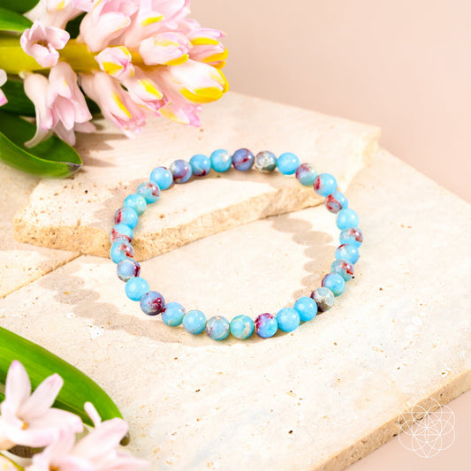 Aqua blue jasper beaded bracelet with small red stone accents