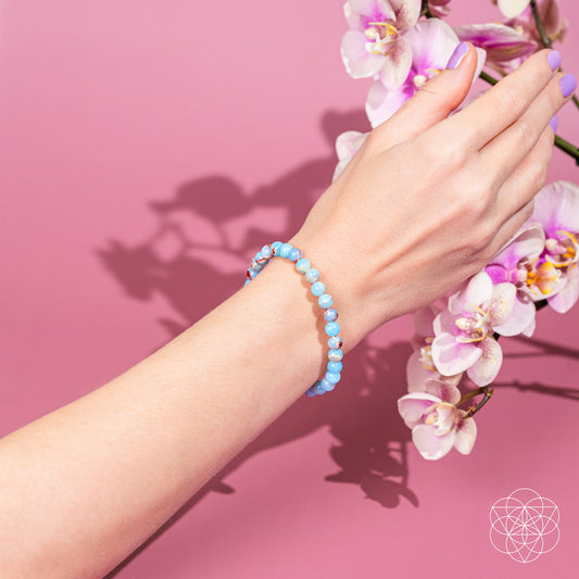 Aqua blue beaded bracelet with subtle red and white flecks on wrist