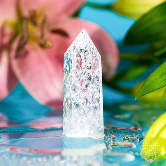 Ice quartz crystal point with clear, faceted prism texture