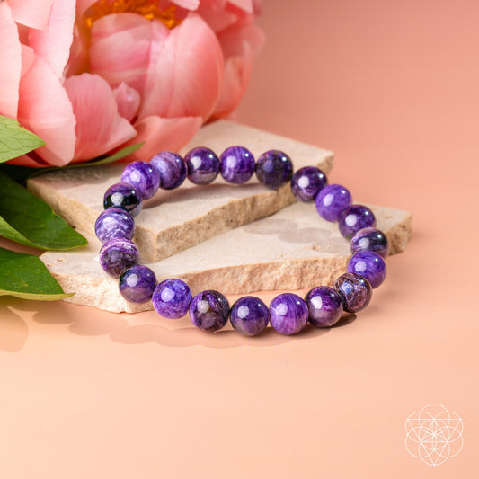 Purple charoite bead bracelet with round stones on a stretch cord