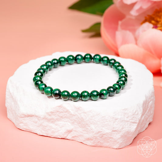 6mm malachite bead bracelet with glossy dark green round beads on display stand