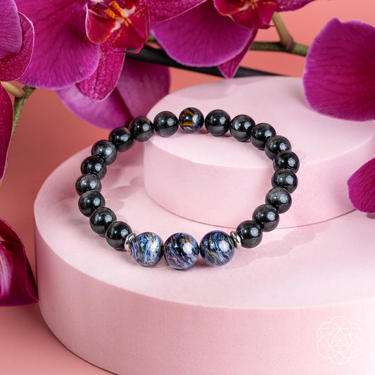Dark beaded bracelet with blue pietersite-style stone accents and glossy black beads