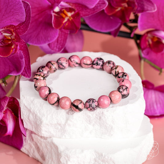 Rhodonite bead bracelet with pink and black marbled round stones on a stretch band