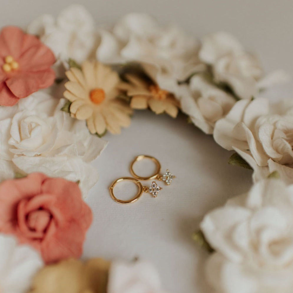 Pair of gold hoops with flower-shaped crystal charms