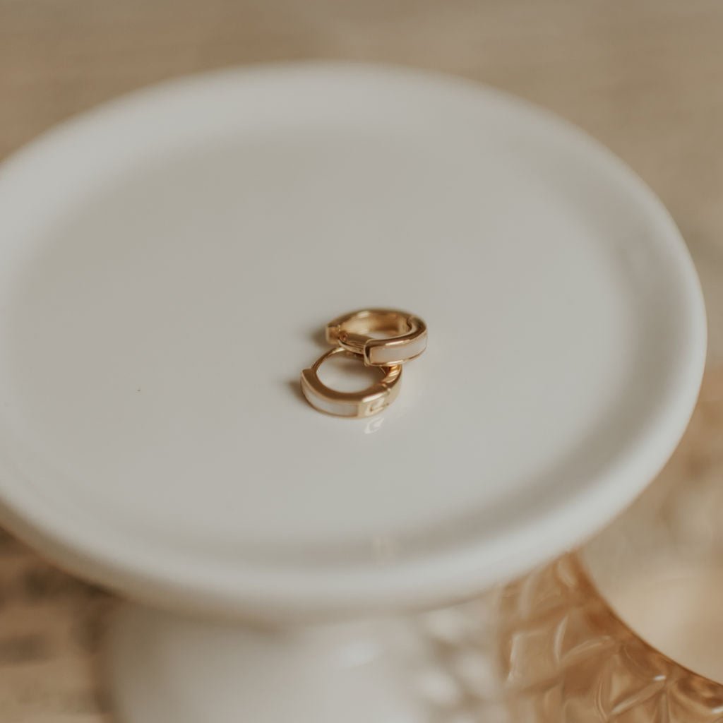 Pair of gold huggie hoops with pale mother-of-pearl inlay