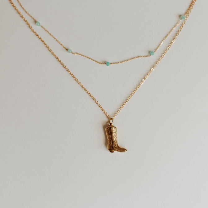 Gold-tone Malibu necklace with turquoise beads beside a boot pendant necklace