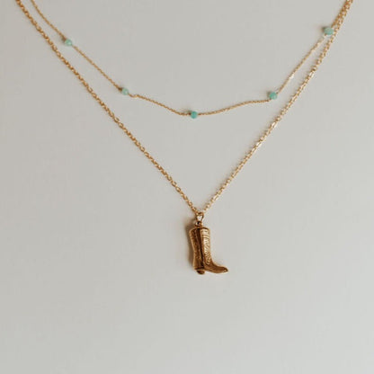 Gold-tone Malibu necklace with turquoise beads beside a boot pendant necklace