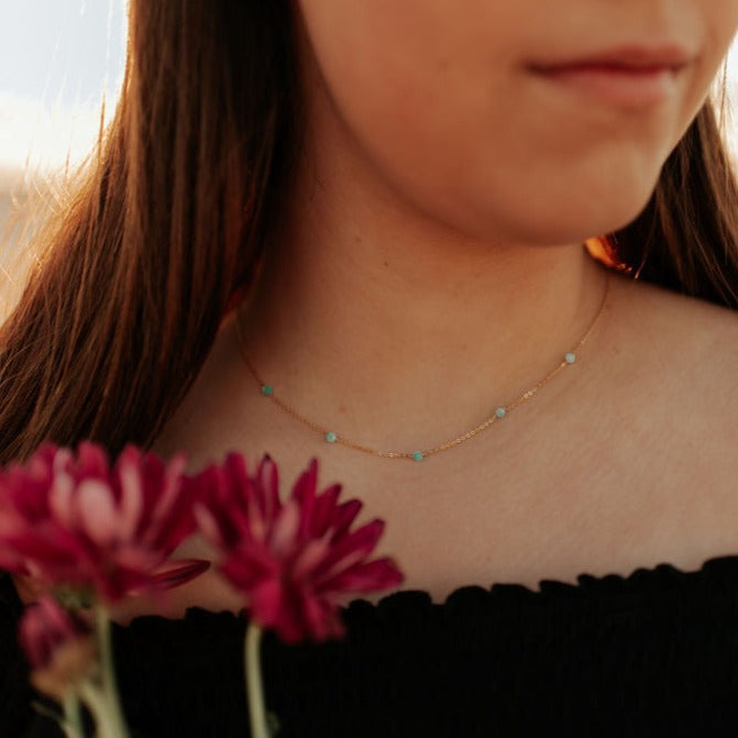 Malibu turquoise bead necklace worn as a delicate gold-tone chain