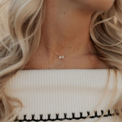 Delicate gold necklace with two clear stones, shown worn at the neck