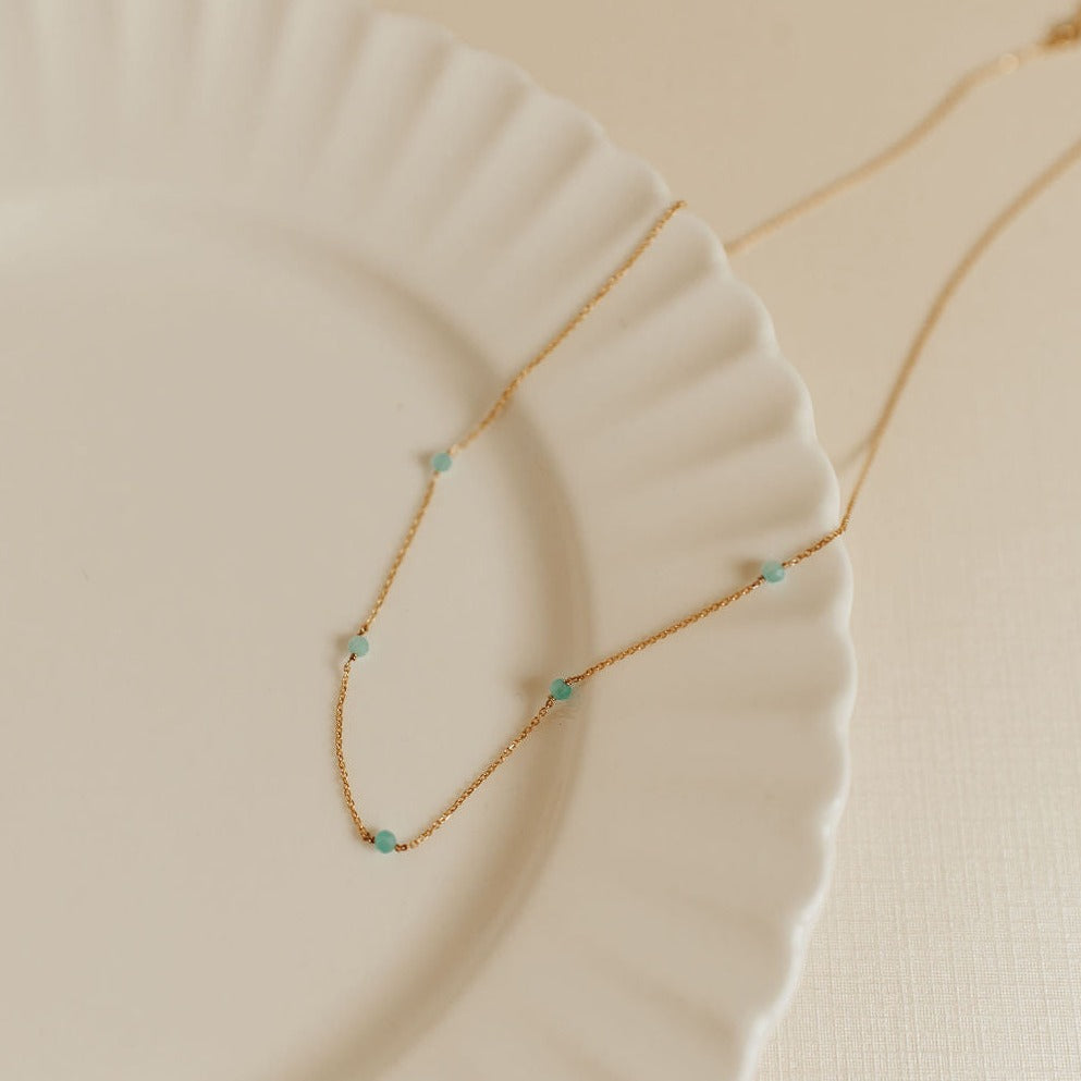 Gold-tone Malibu necklace with small turquoise beads along a fine chain