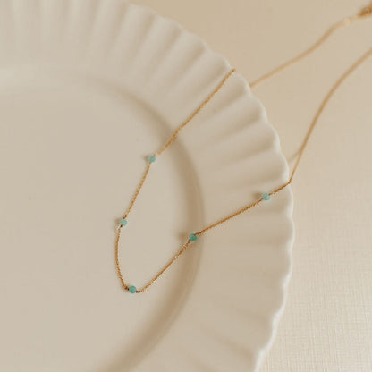 Gold-tone Malibu necklace with small turquoise beads along a fine chain