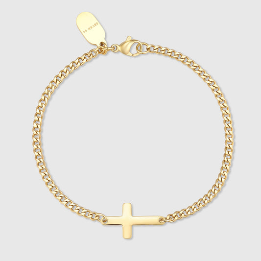 Gold chain bracelet with small cross charm and round link clasp