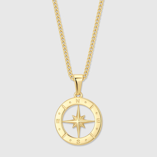 Gold compass pendant necklace with circular dial and north star detail on chain