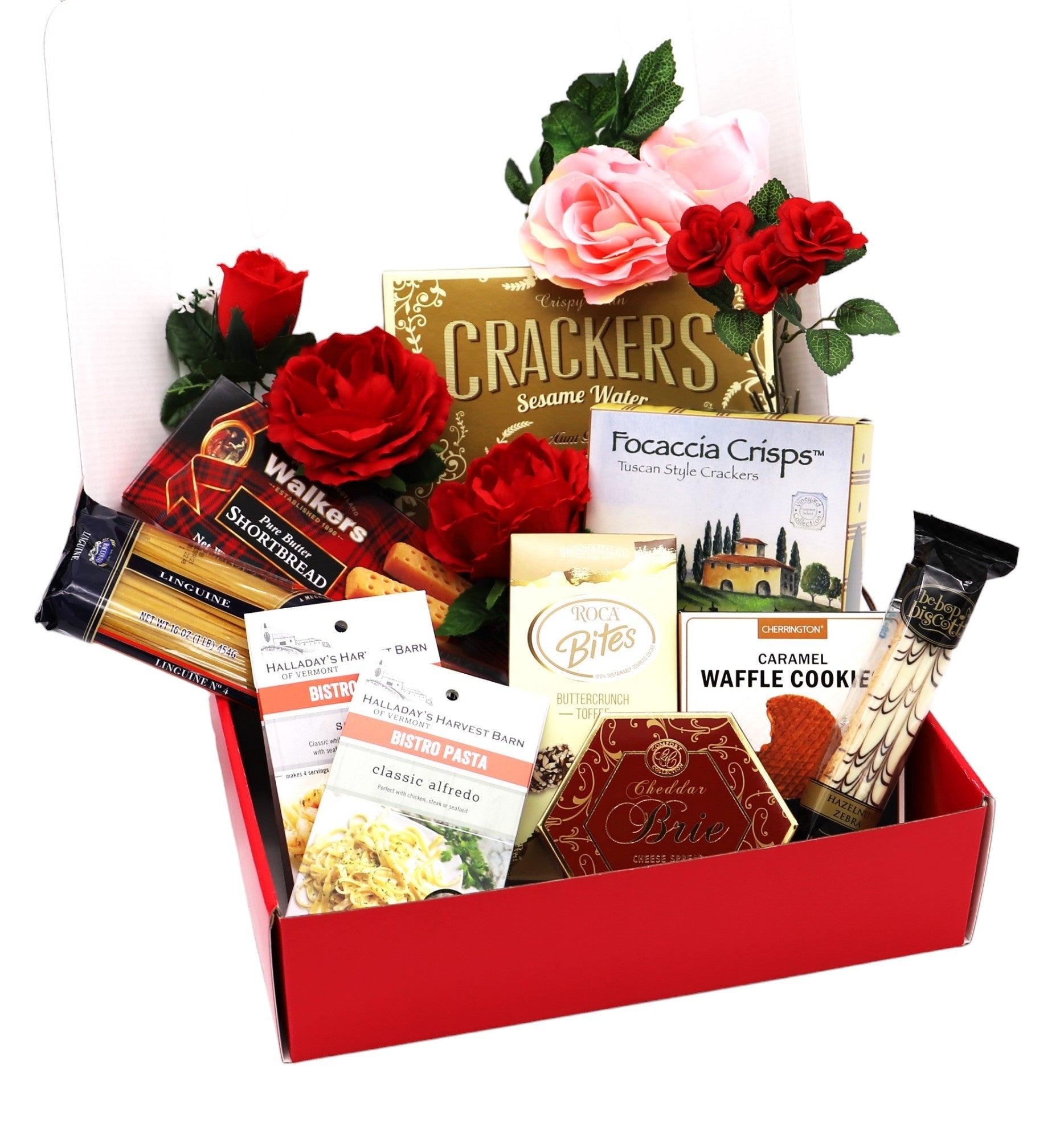 Red gift box with assorted crackers, cookies, wafers, and roses