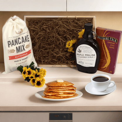 Breakfast gift crate with pancake mix bag, maple syrup, coffee, and pancakes