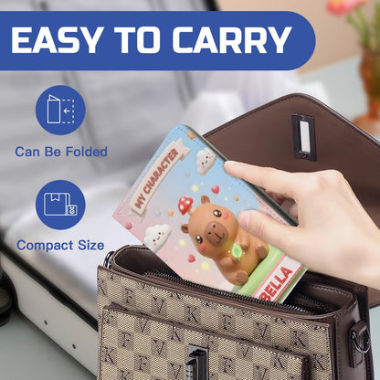 Personalized passport holder open, capybara cover and 'BELLA' name strip